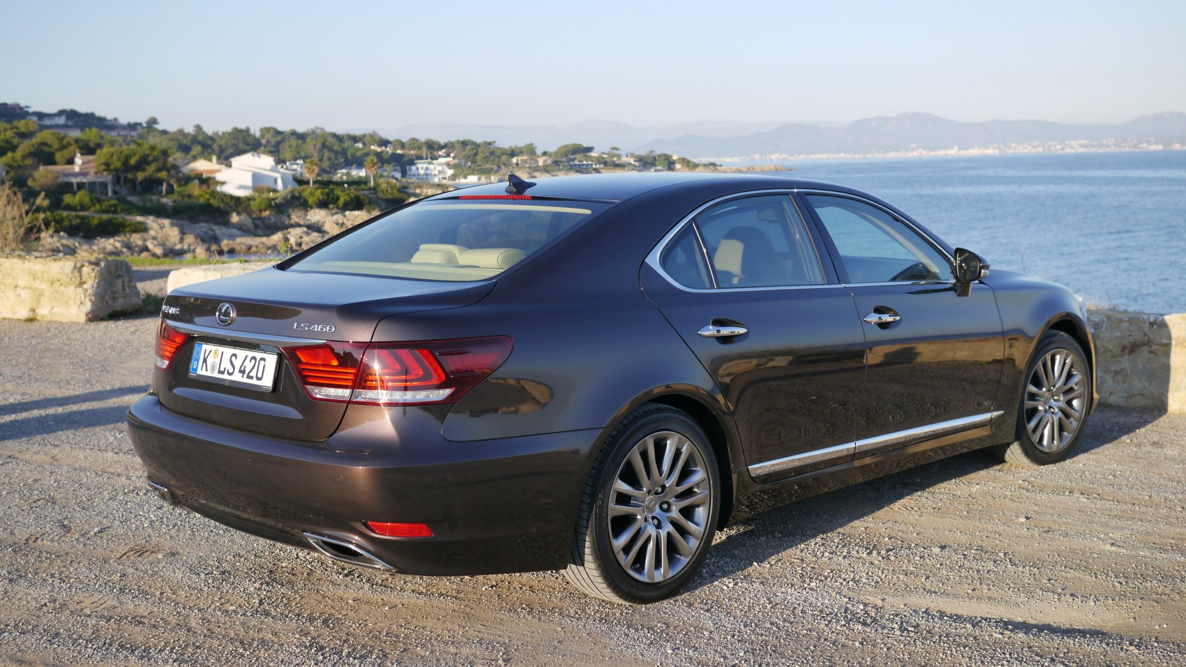 Rear and side view of luxury sedan with distinctive taillights and alloy wheels