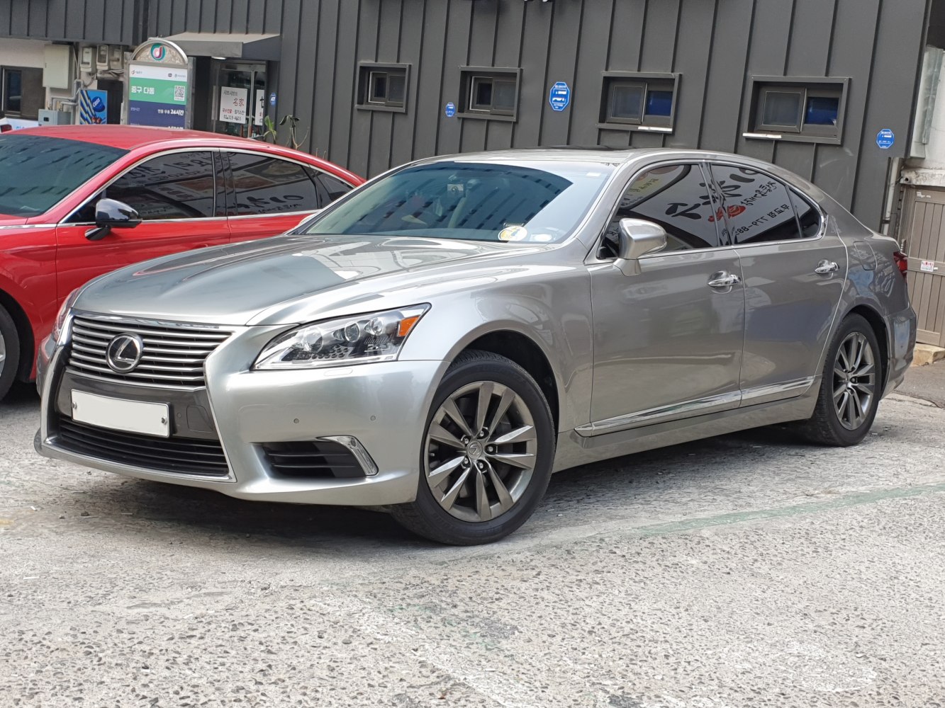 Silver luxury sedan with distinctive grille and alloy wheels.
