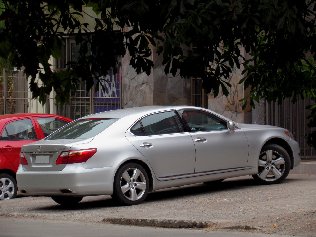Luxury sedan rear and side profile with alloy wheels and sleek design