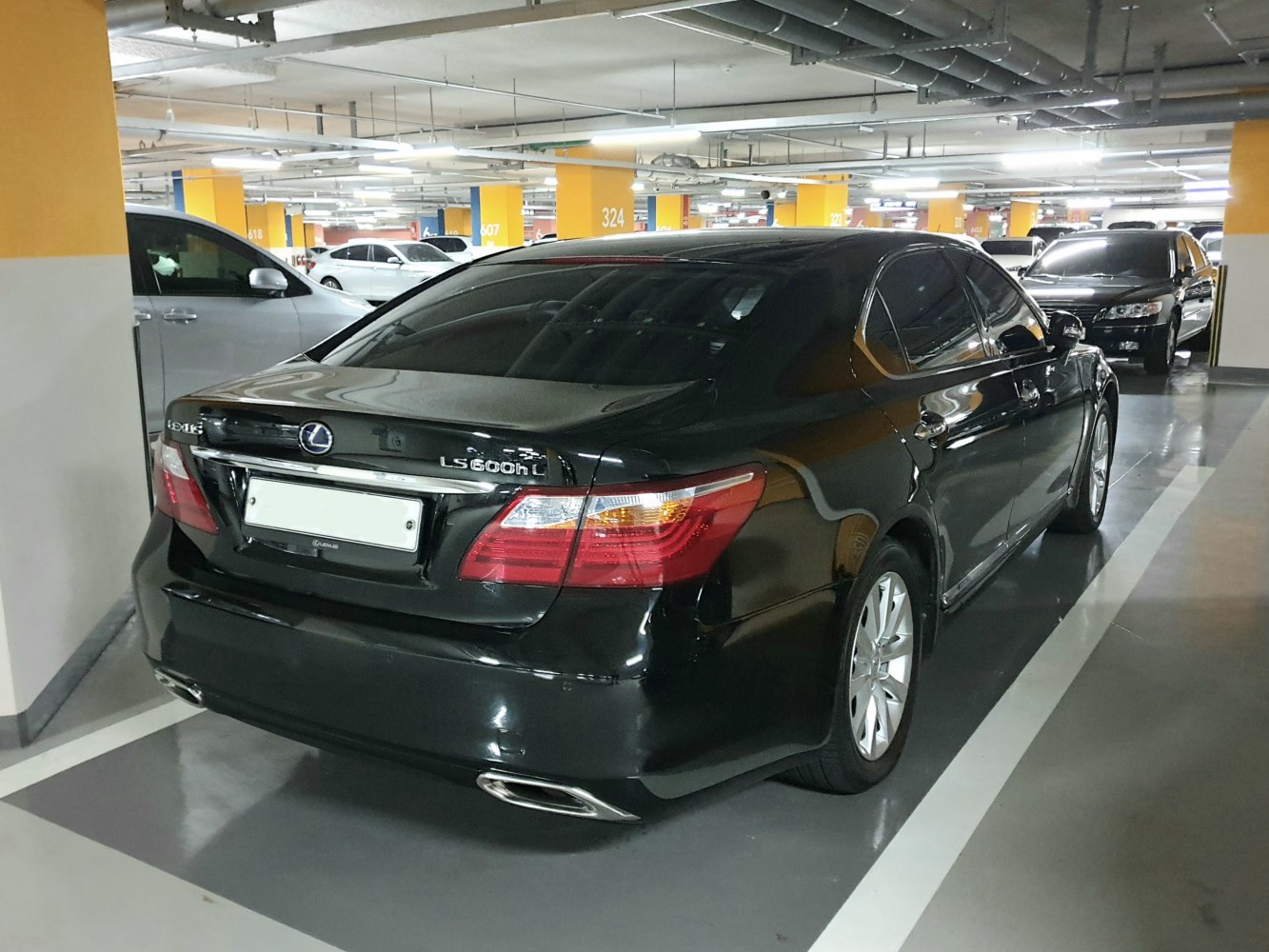 Rear view of luxury sedan with distinctive taillights and dual exhaust