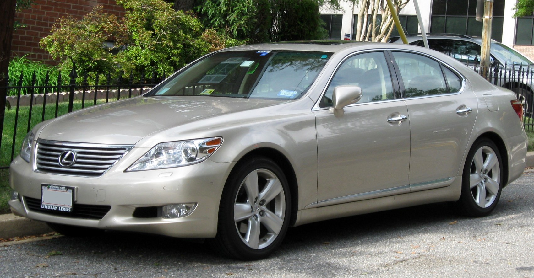 Front and side exterior view of a luxury sedan with chrome grille and alloy wheels