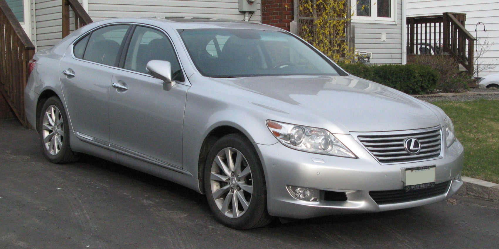 Silver luxury sedan with sleek front headlamps and alloy wheels