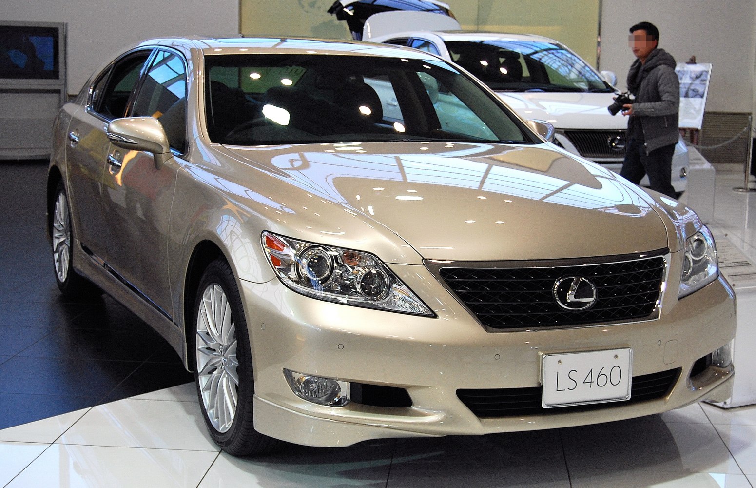 Front profile of a luxury sedan with updated headlights and grille.