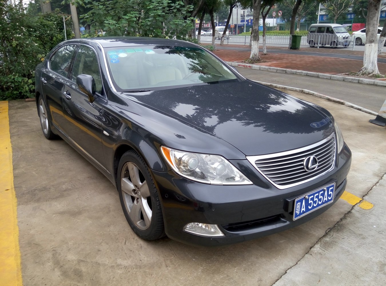 Front three-quarter view of car with signature grille and headlights