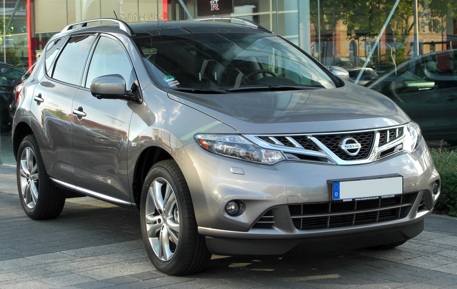 Front side view of a silver modern SUV with alloy wheels
