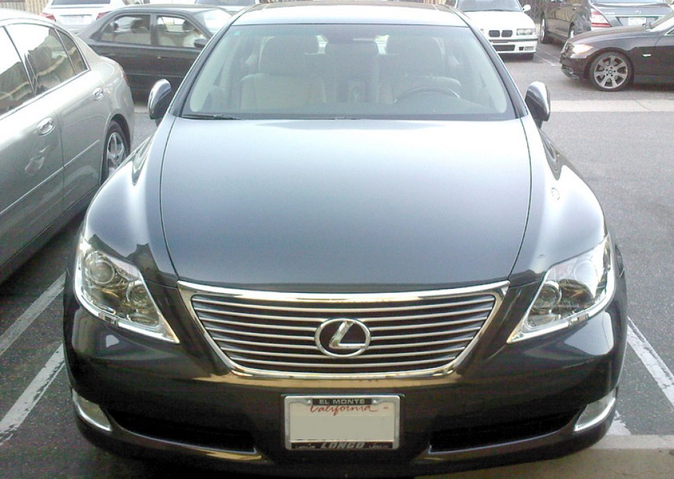 Front luxury sedan with chrome horizontal grille and dual projector headlights