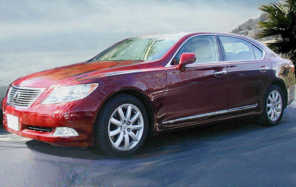 Red luxury sedan front side profile with chrome trim and alloy wheels
