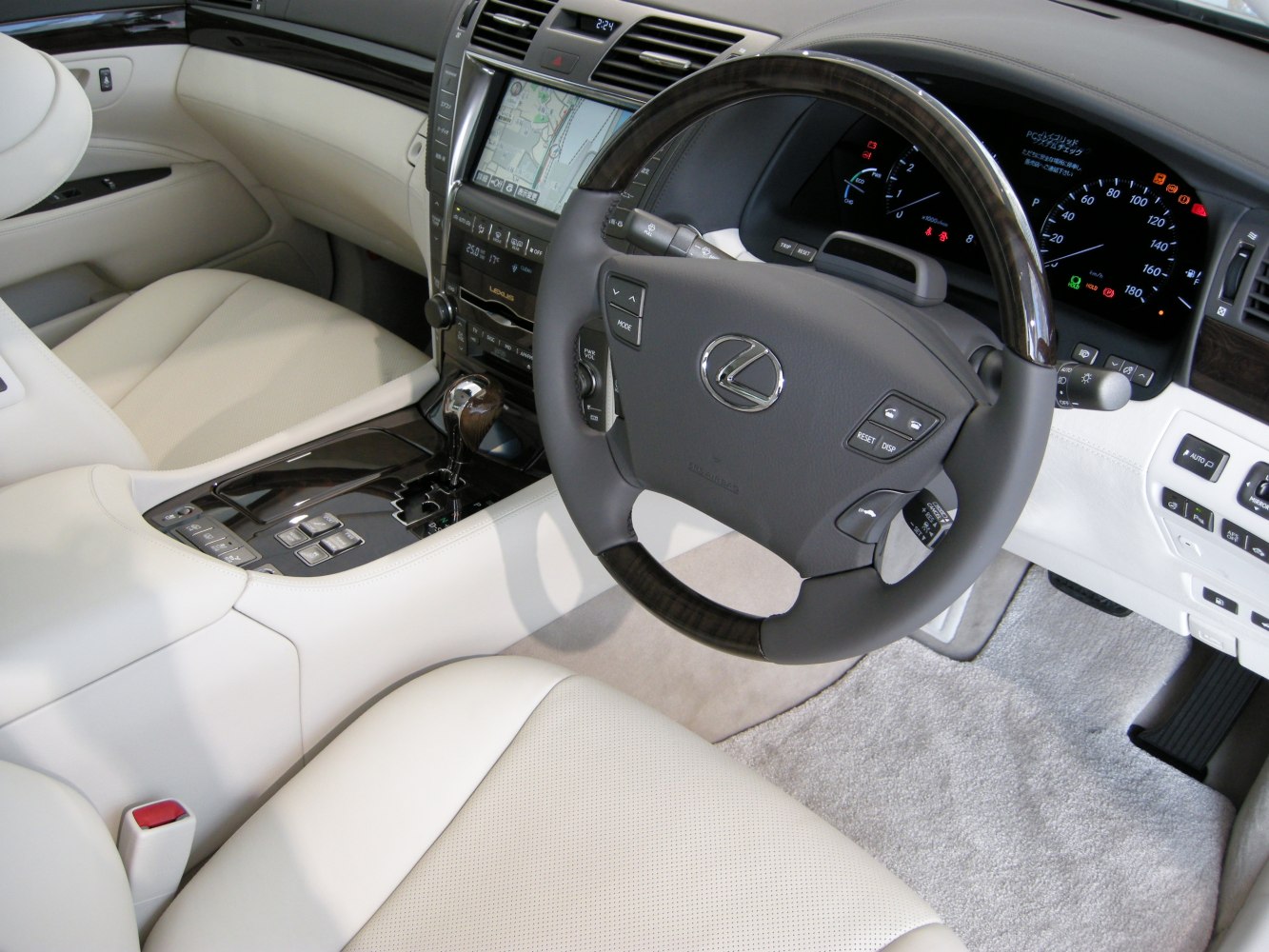 Luxury beige leather seats with advanced dashboard and steering wheel controls