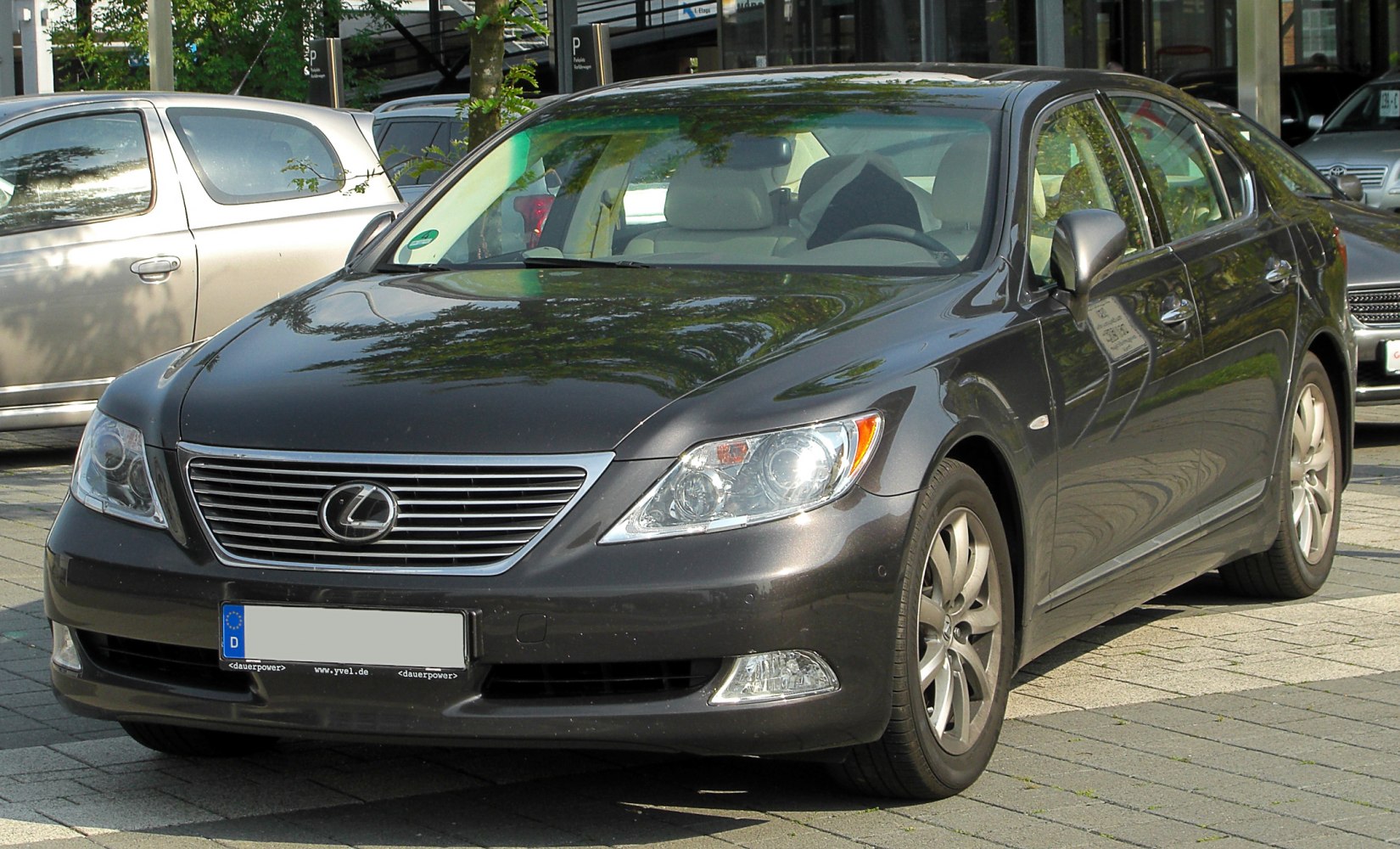 Luxury sedan front view with LED headlights and prominent grille