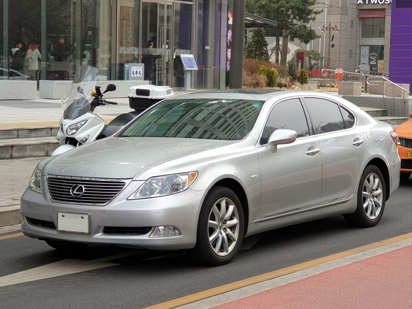 Silver luxury sedan with smooth curves and multi-spoke alloy wheels