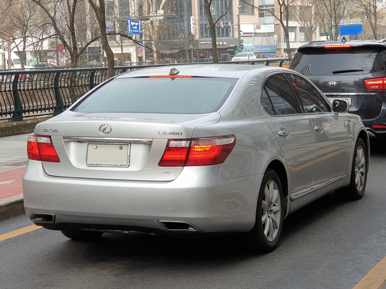 Rear view of a luxury sedan with taillights and dual exhausts