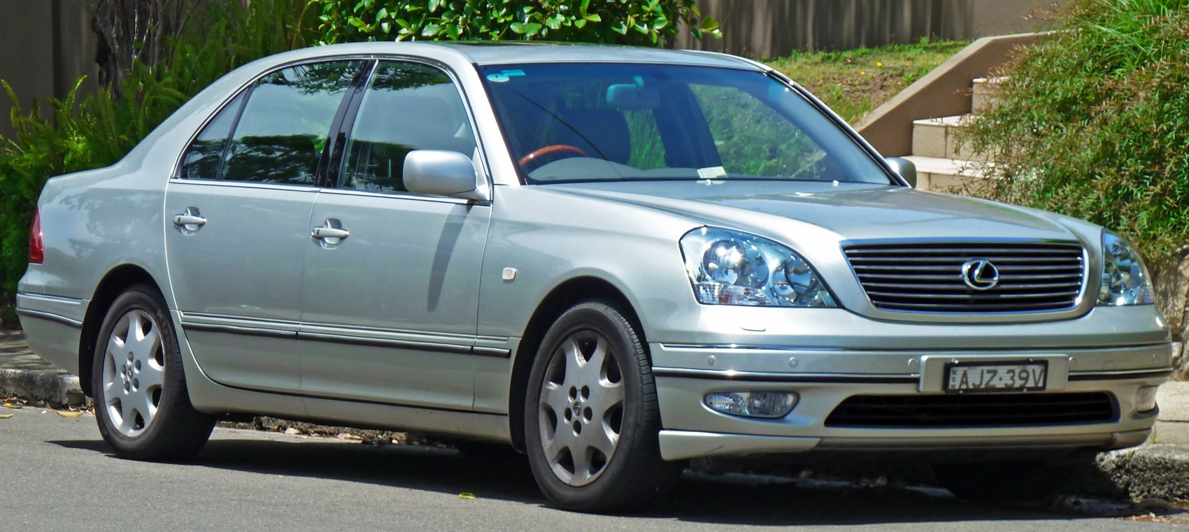 Silver luxury sedan front side view with distinctive grille and alloy wheels