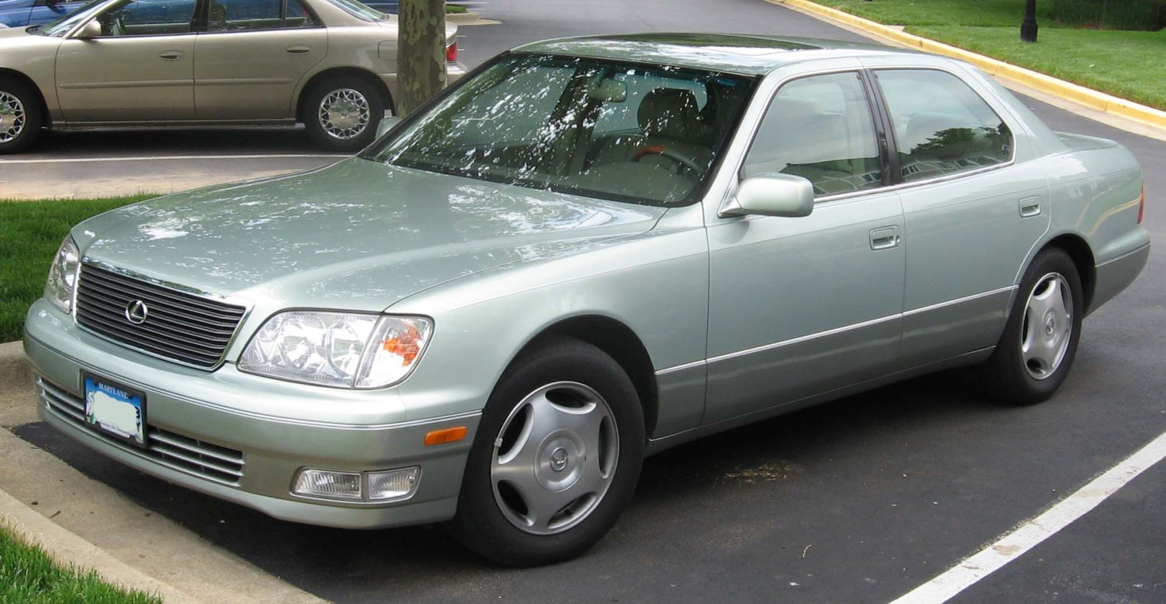 Front and side view of a luxury sedan with sleek headlights and grille