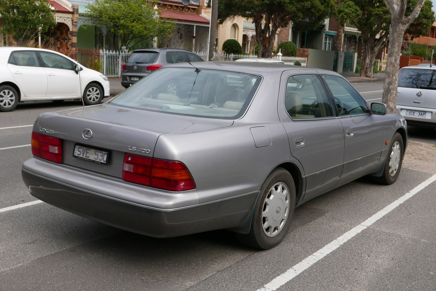 Rear and side profile of a luxury sedan from the 1990s.
