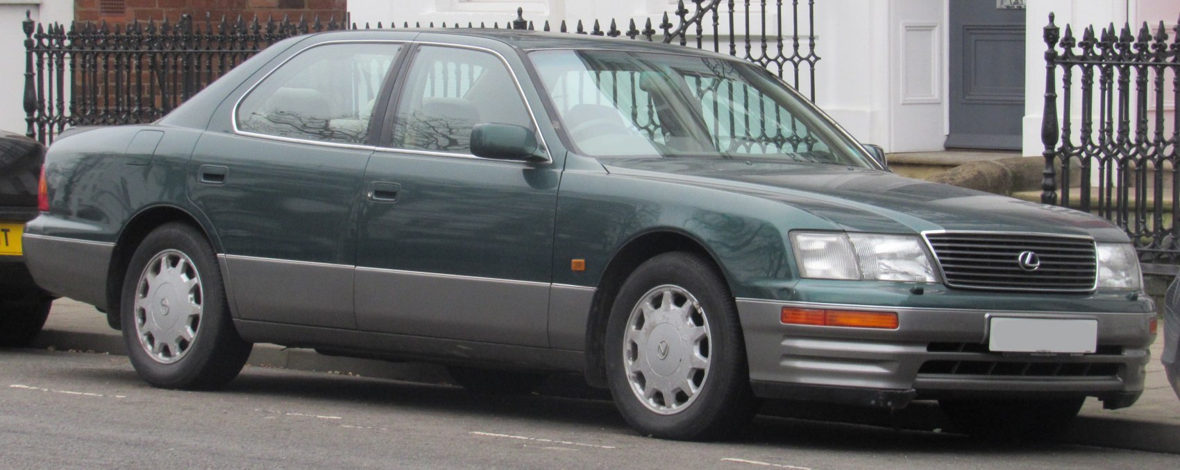 Front grille and side profile of a mid-90s luxury sedan