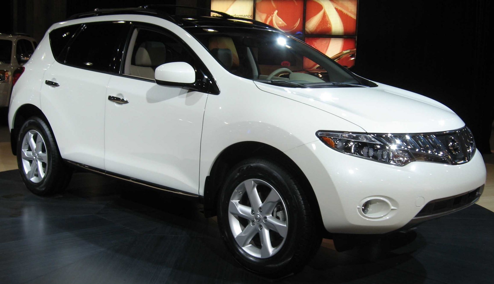 White SUV with sleek front-side view, alloy wheels, and modern headlights
