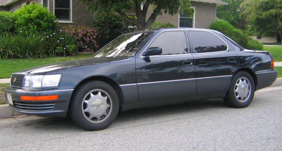 Side profile of 1993 luxury sedan with tinted windows and classic wheel covers.