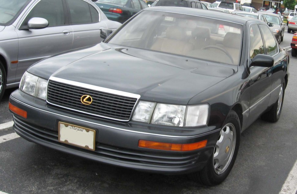 Front view of early 90s luxury sedan with rectangular headlights and chrome grille