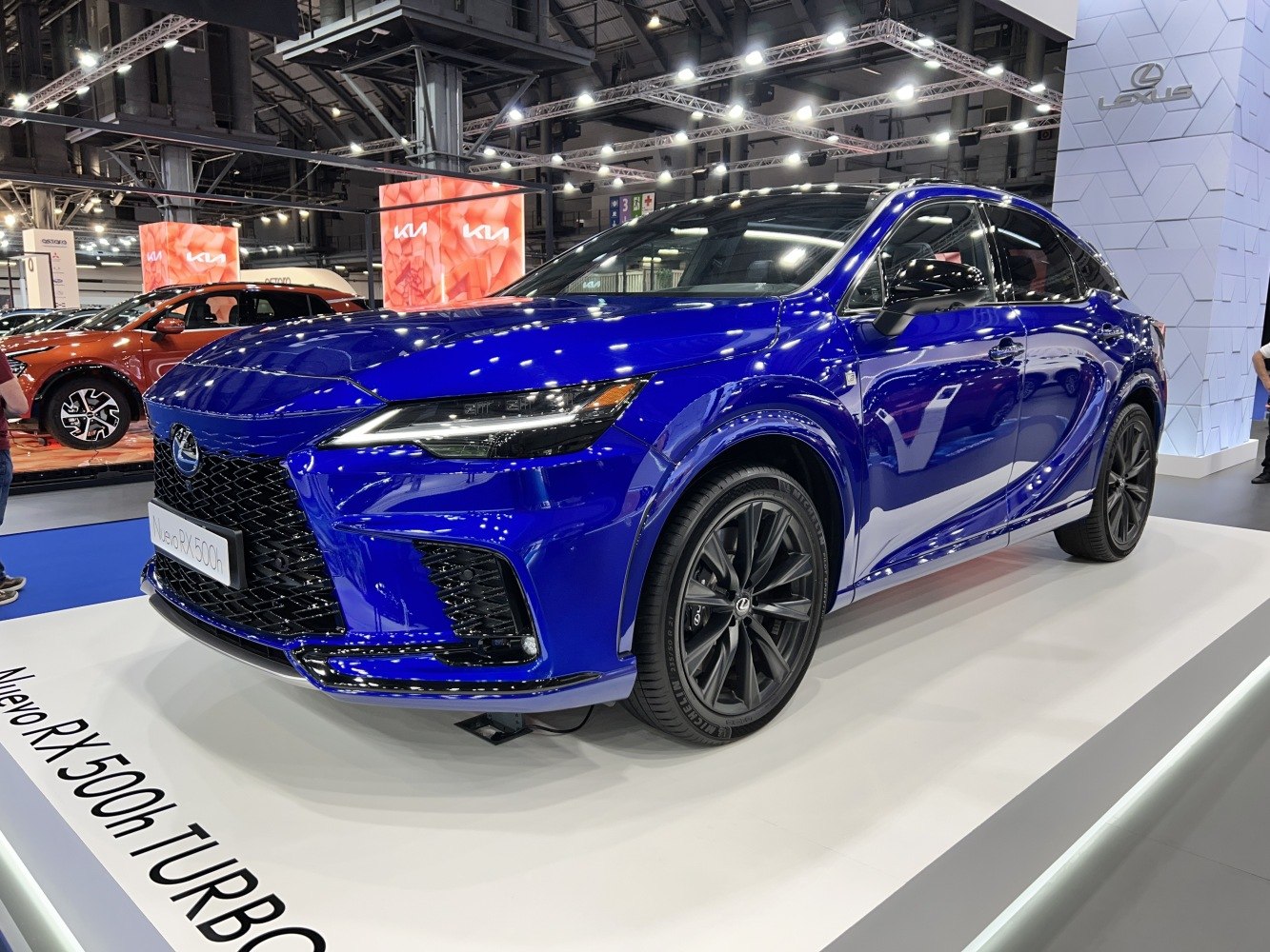 Modern blue SUV with aggressive grille and black multi-spoke wheels