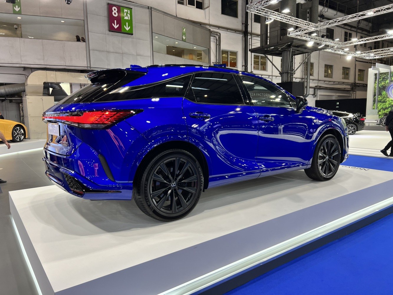 Blue luxury SUV rear and side profile with black wheels and distinctive tail lights