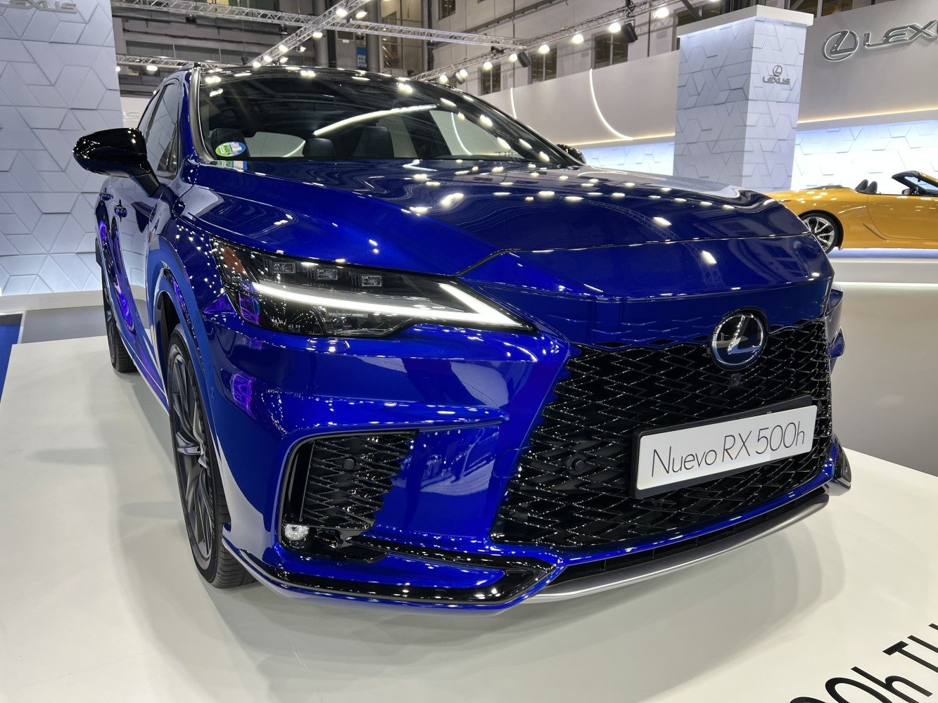 Blue luxury SUV front with LED headlights and mesh grille