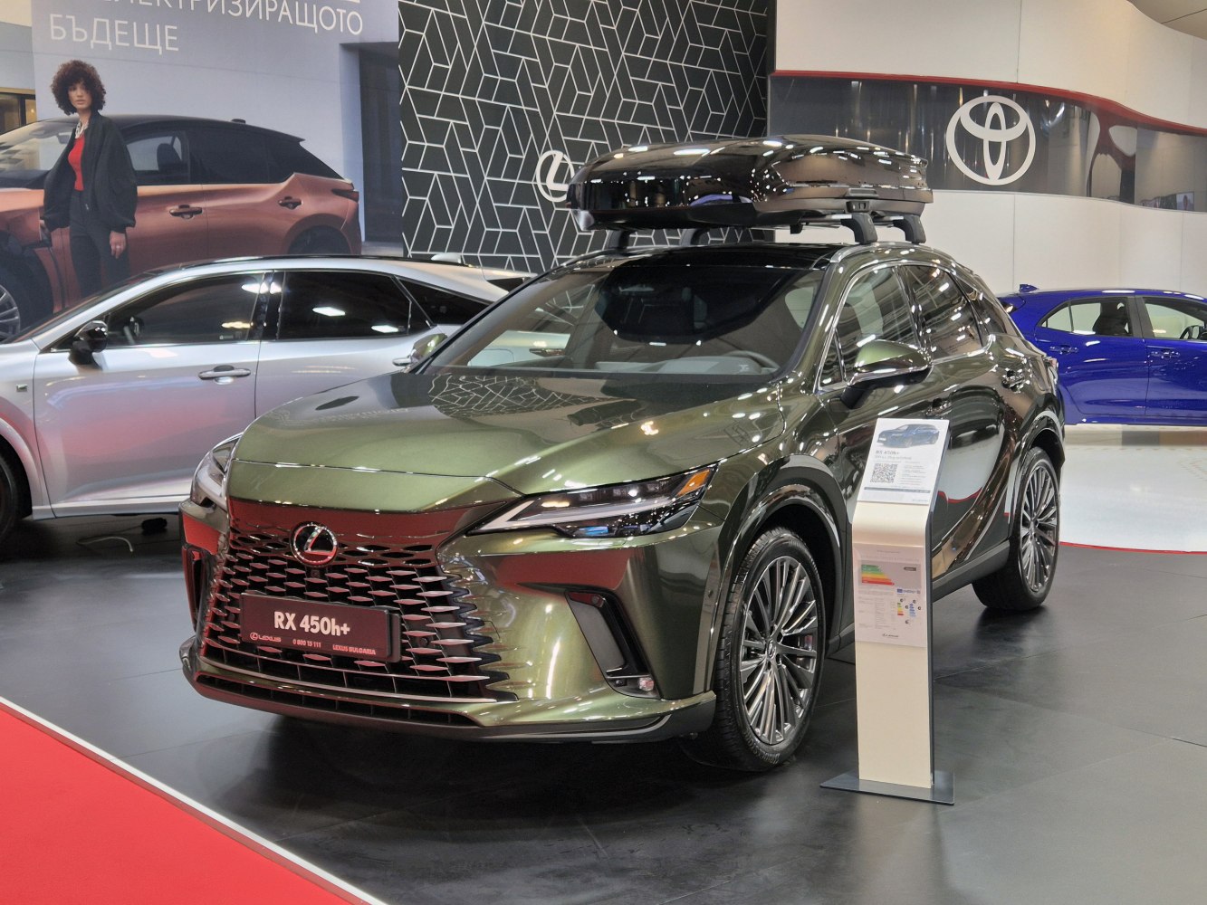 Modern SUV with large roof box and aggressive front grille.