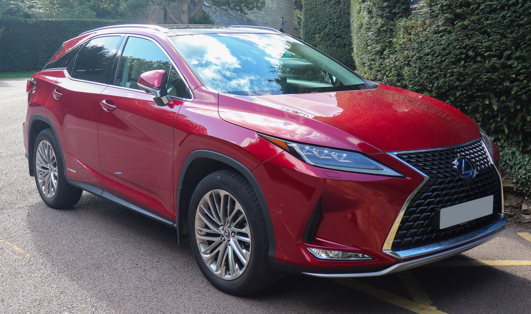 Front-side view of red SUV with distinctive grille and headlights