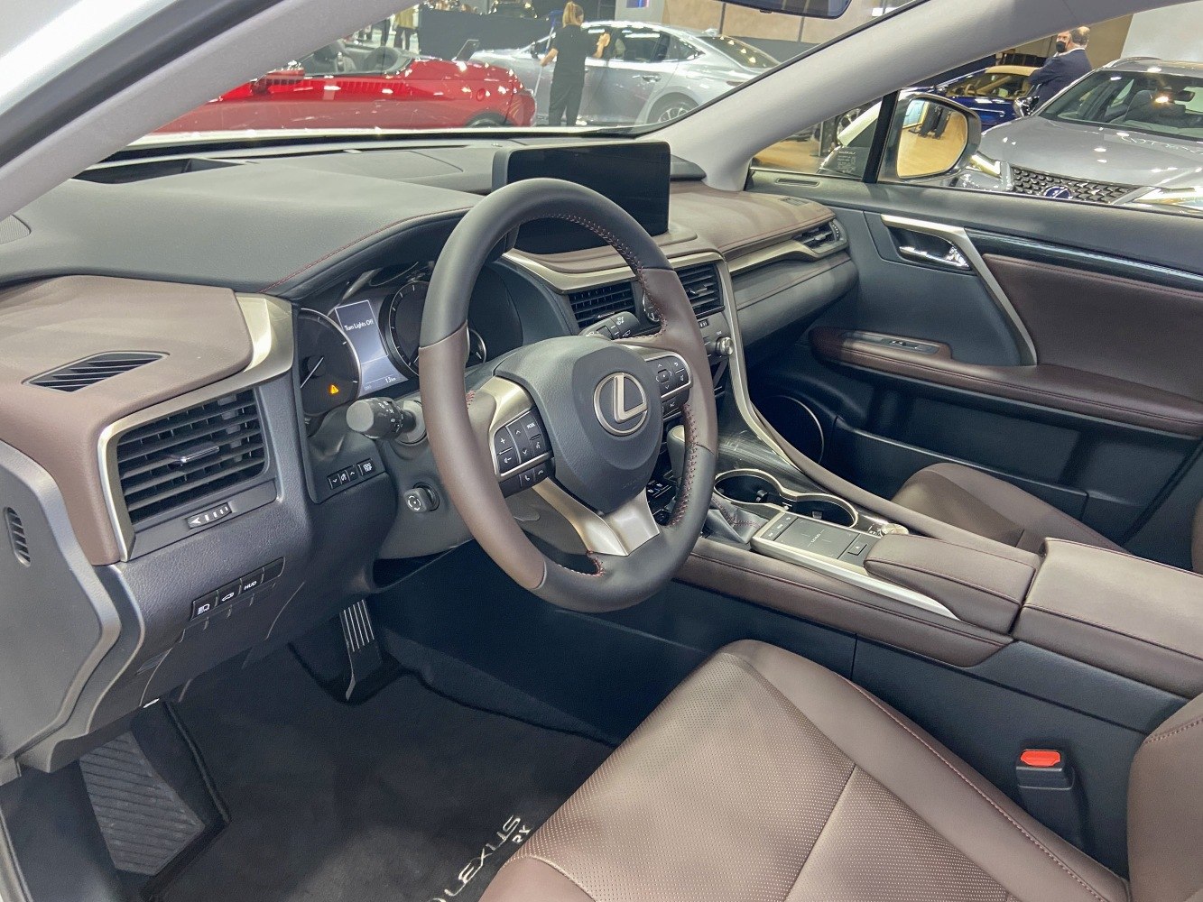 Luxury dashboard and leather-wrapped steering wheel in modern SUV interior