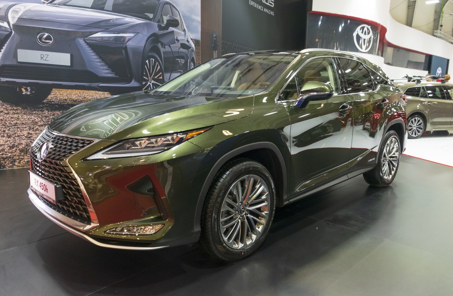 Hybrid SUV with sharp headlights and intricate front grille.
