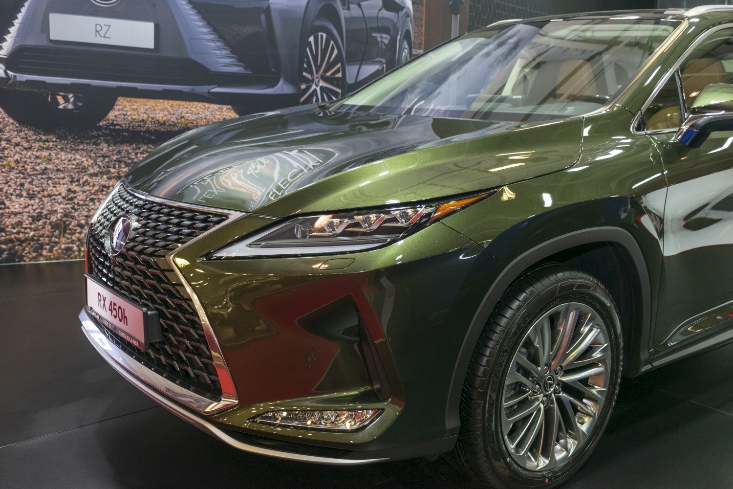 Front grille, headlight, and alloy wheel of luxury SUV.