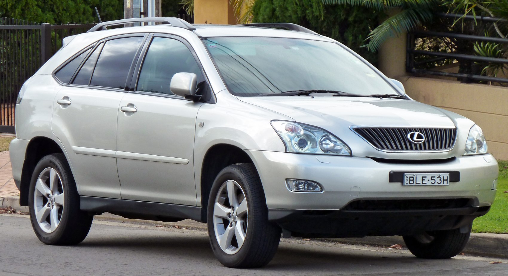 Silver SUV front side view with alloy wheels and roof rails