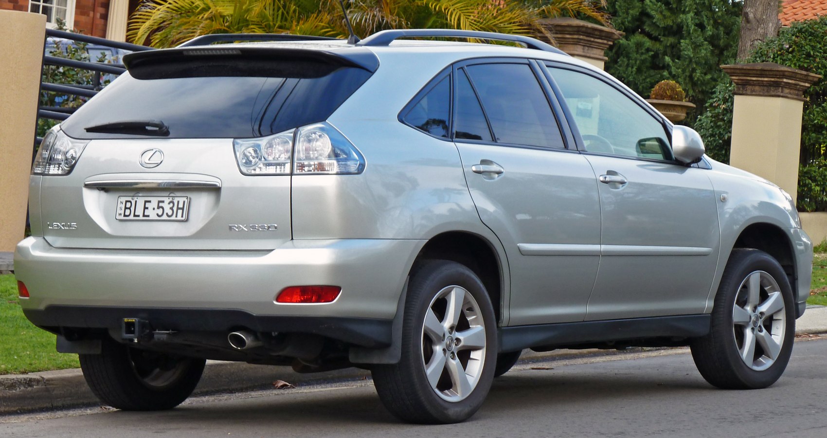 Rear side of silver SUV with clear taillights and roof rails