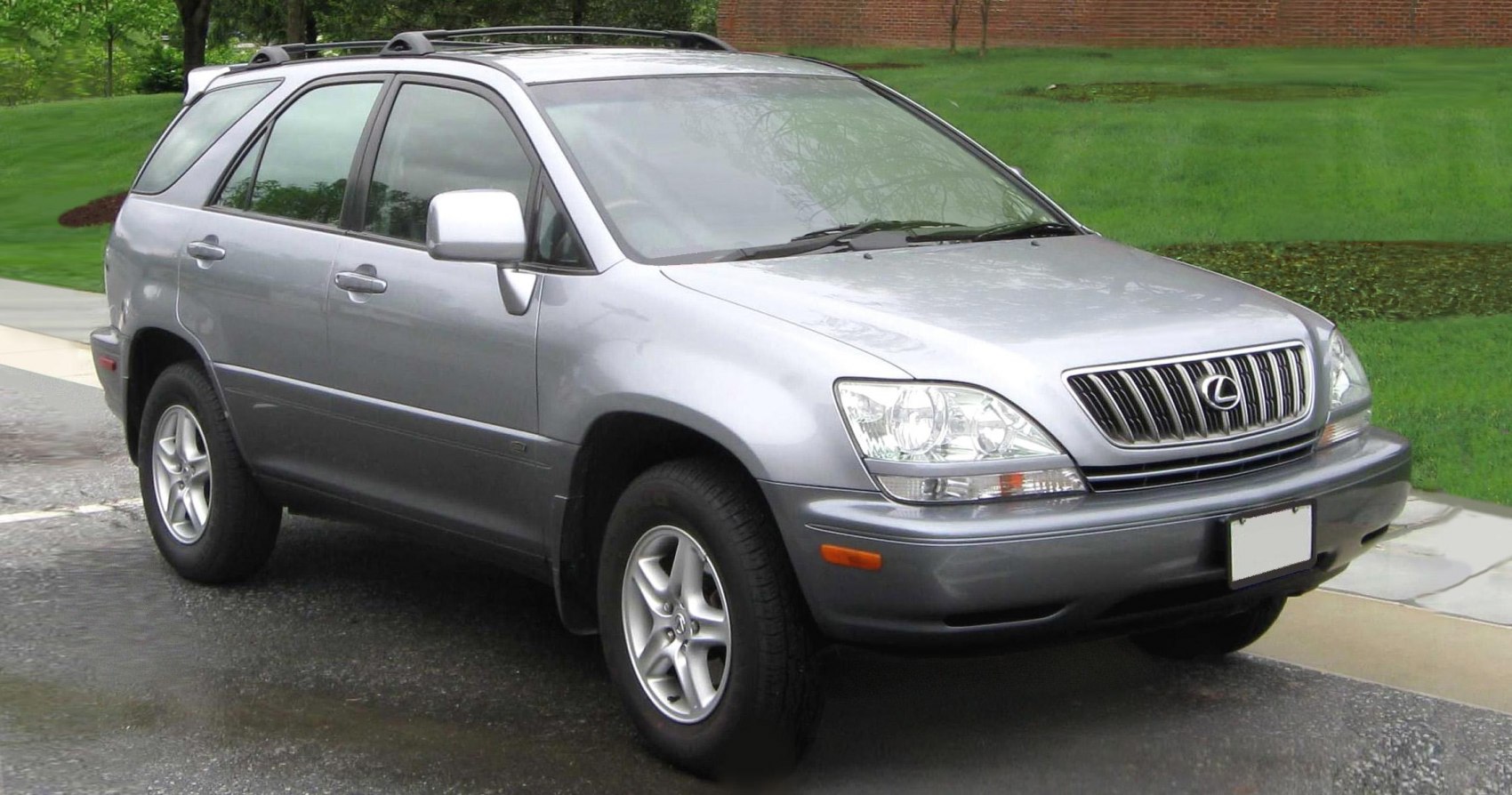 Silver SUV front side view with roof rails and alloy wheels