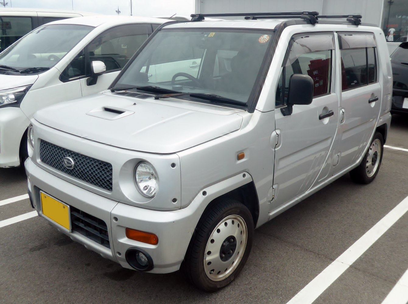 Boxy compact SUV with round headlights and front grille