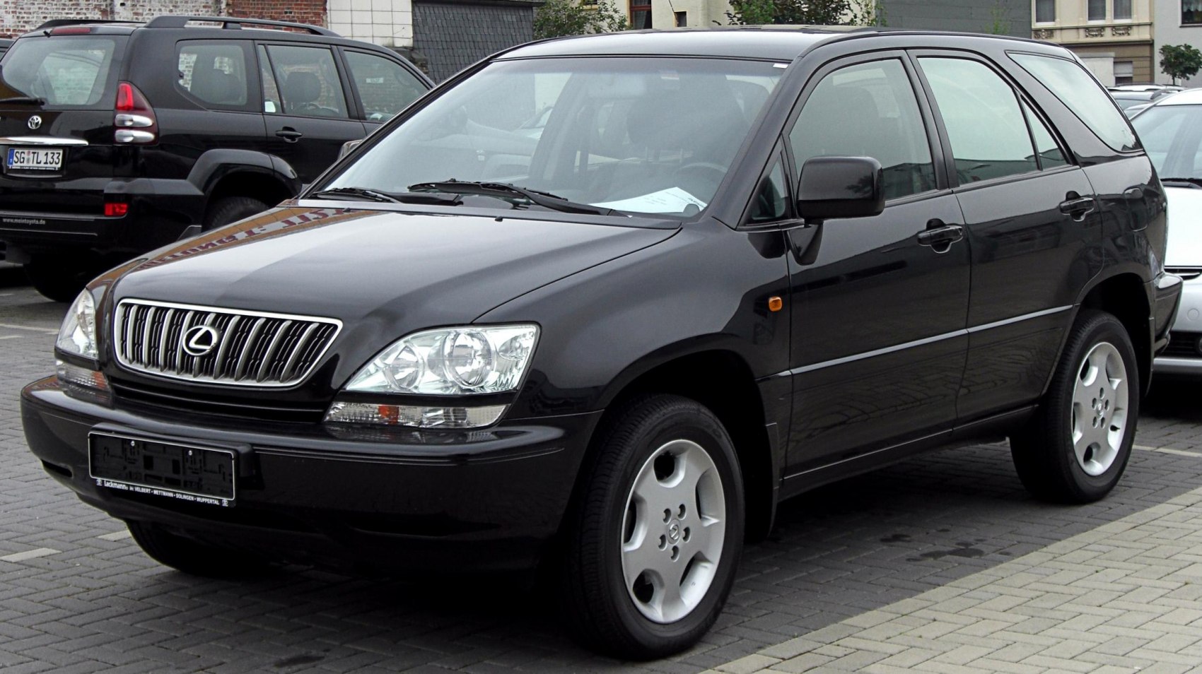 Black luxury SUV front-side view with distinctive grille and headlights