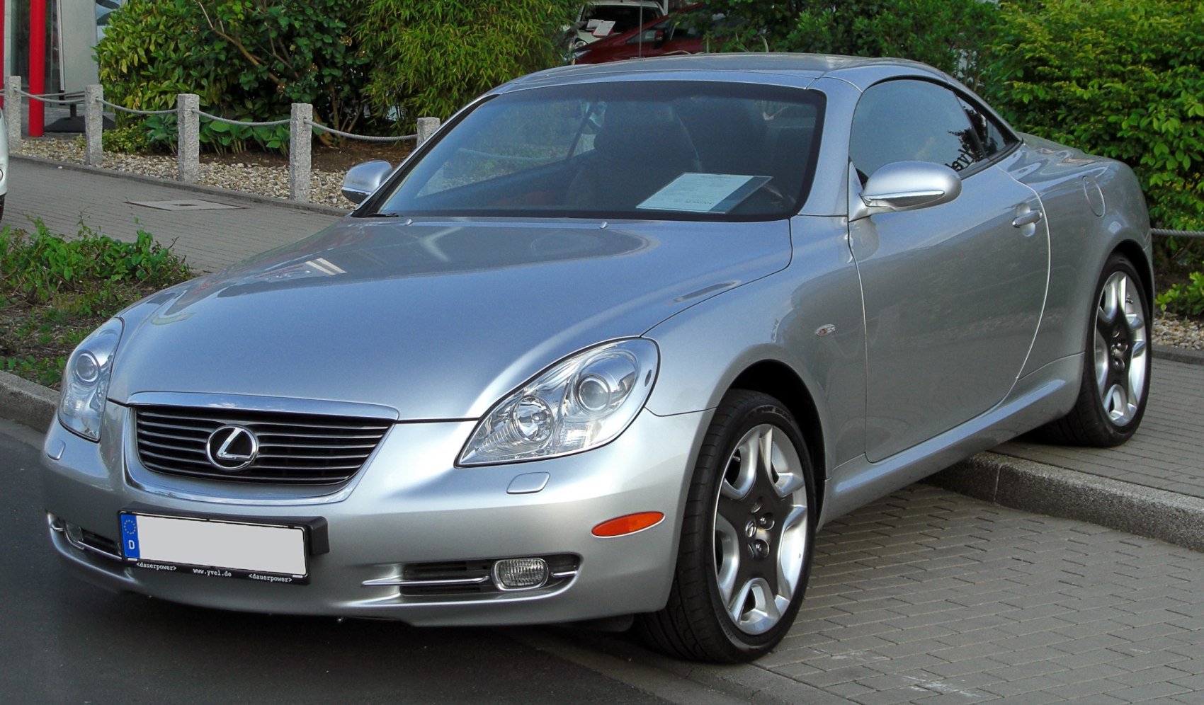 Silver luxury coupe with aerodynamic design and front headlights