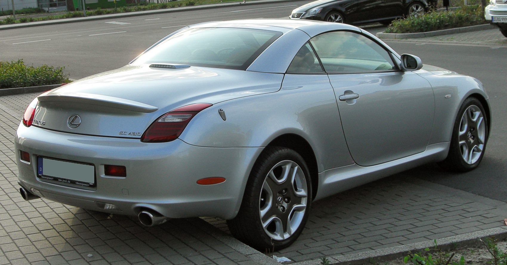 Convertible sports coupe rear with spoiler and dual exhaust