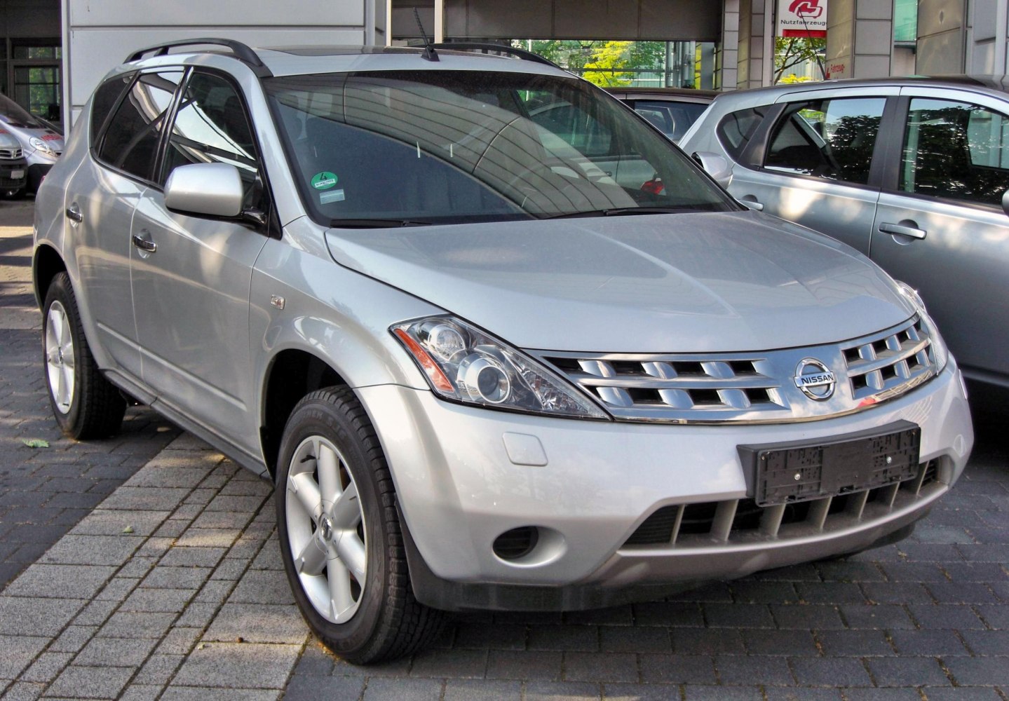 Front side view of SUV with distinct grille and headlight design