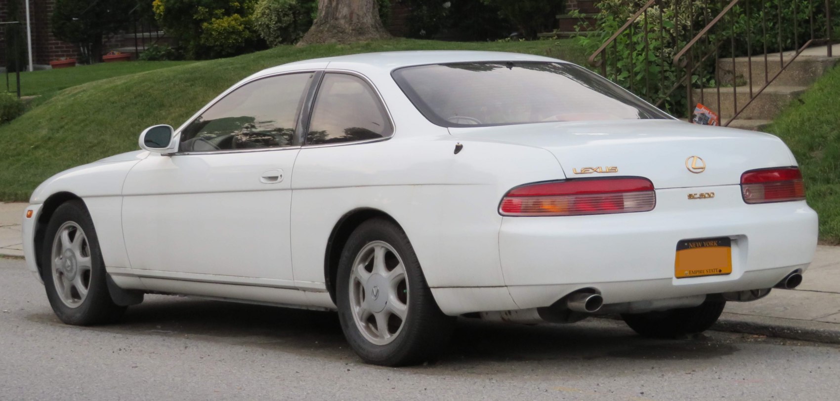 Rear-side view with dual exhaust and smooth body contours