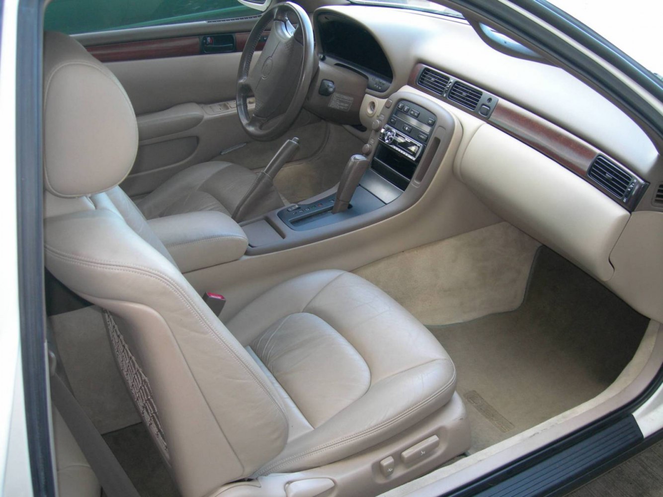 Beige leather seats and wood trim dashboard