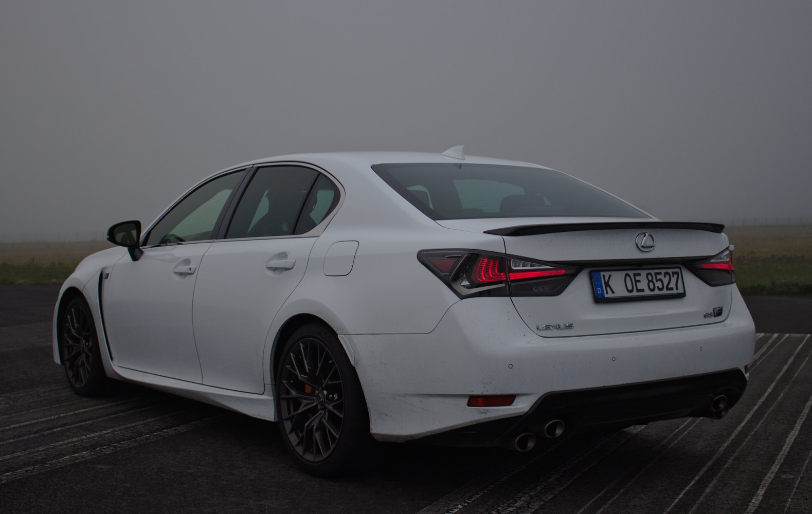 Rear view of a sedan with LED taillights and quad exhaust setup