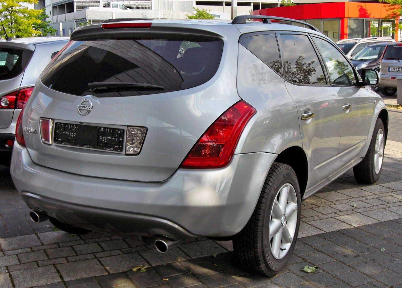SUV rear with distinctive tail lights and dual exhaust pipes