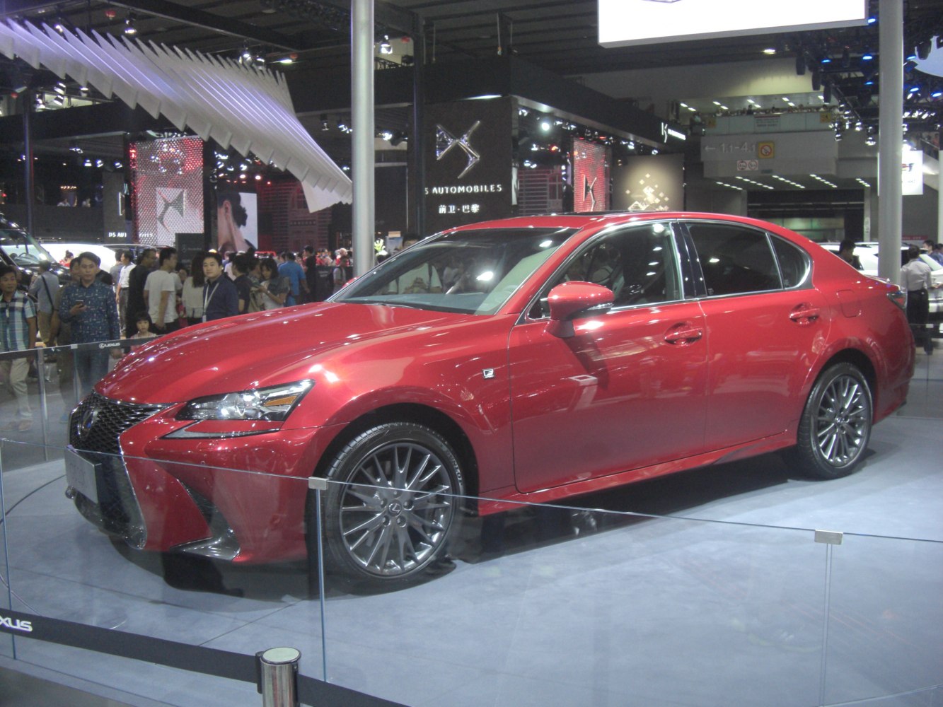 Red luxury sedan front and side view with alloy wheels and sleek headlights