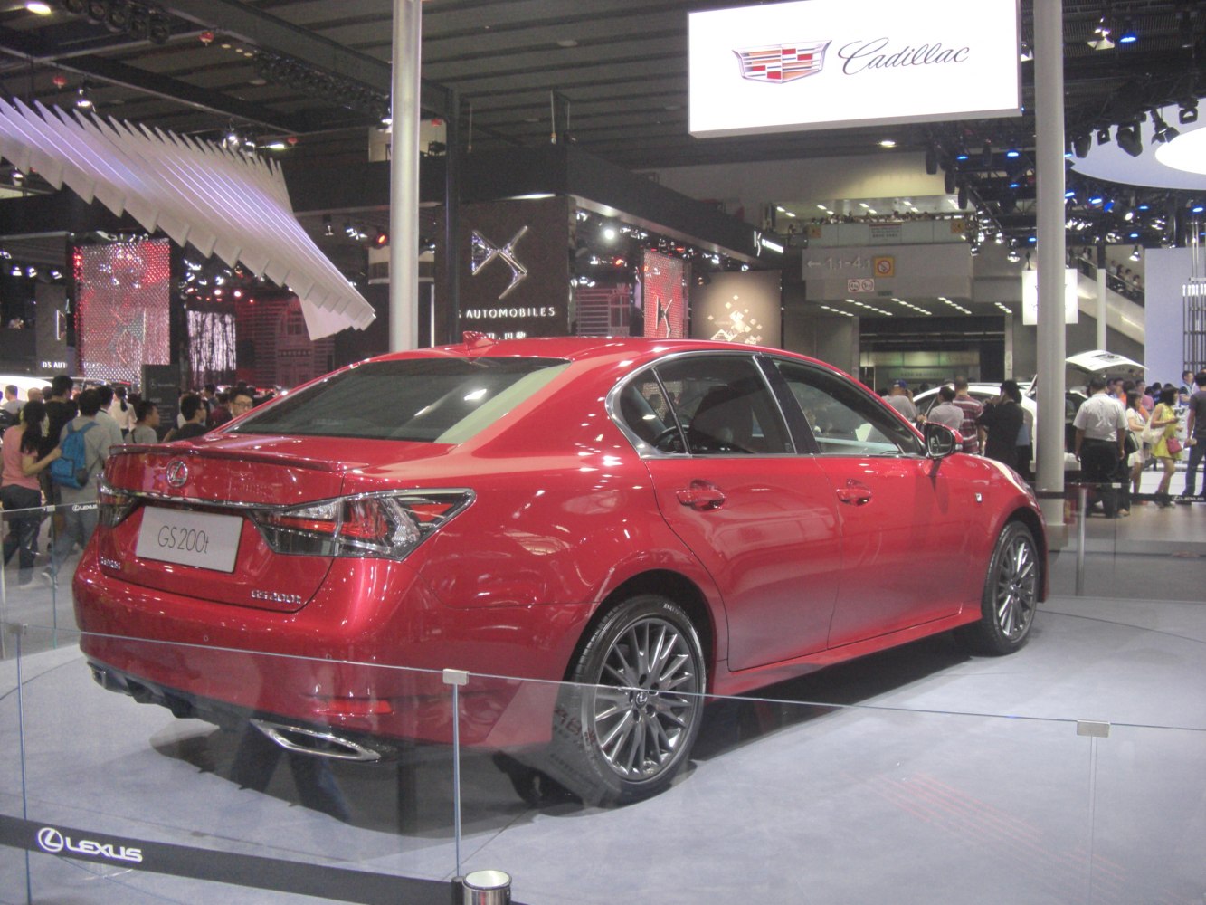 Red sedan with sleek rear light design and alloy wheels