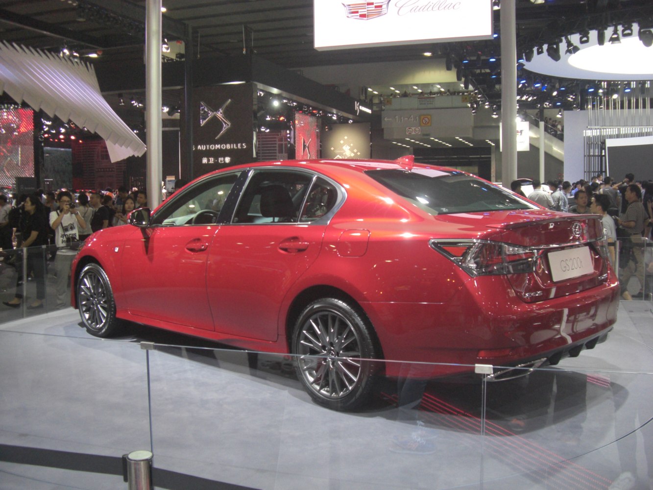 Rear-side view of red mid-size sedan with sporty wheels