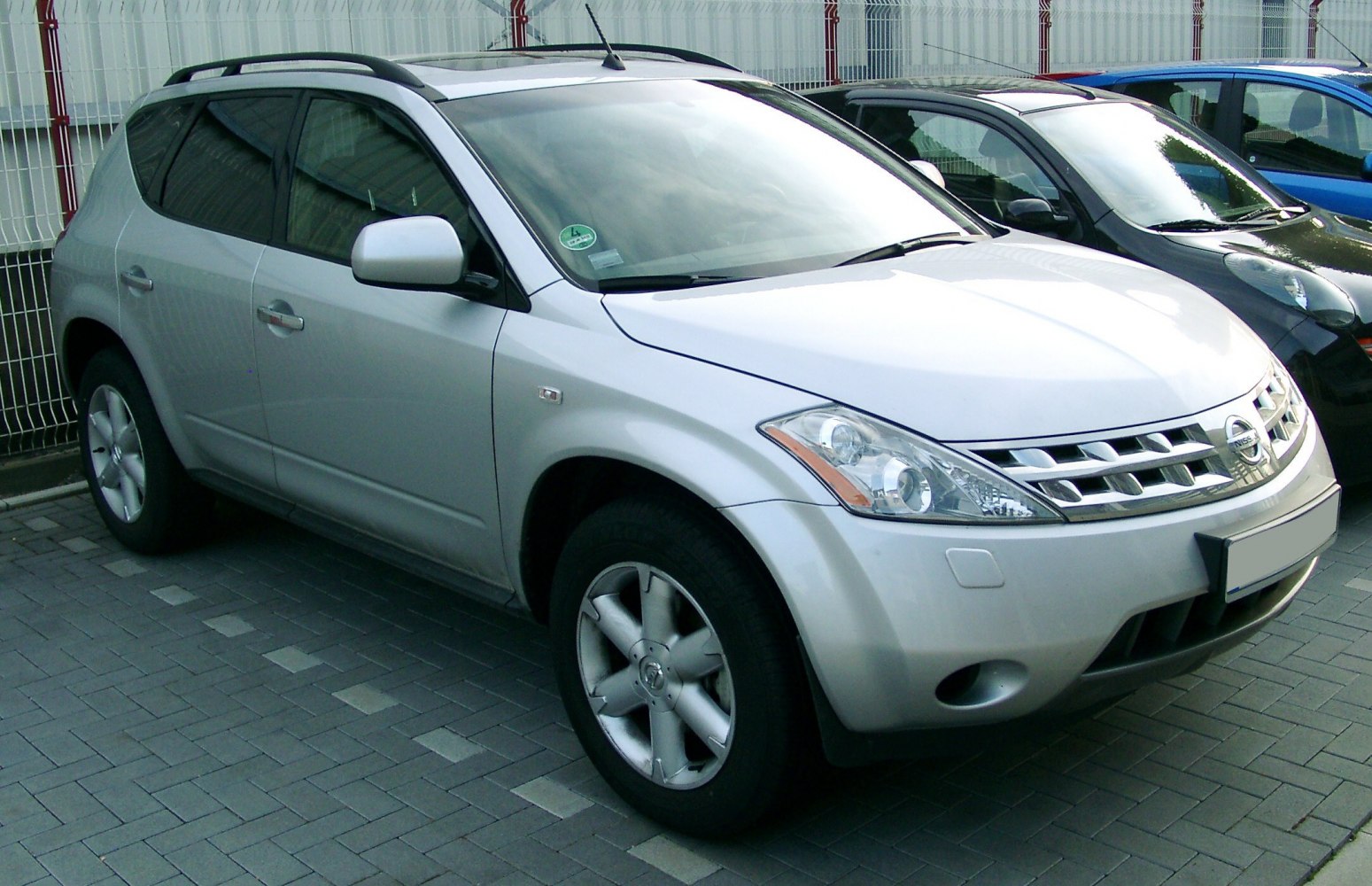 Silver SUV front side view with alloy wheels and grille