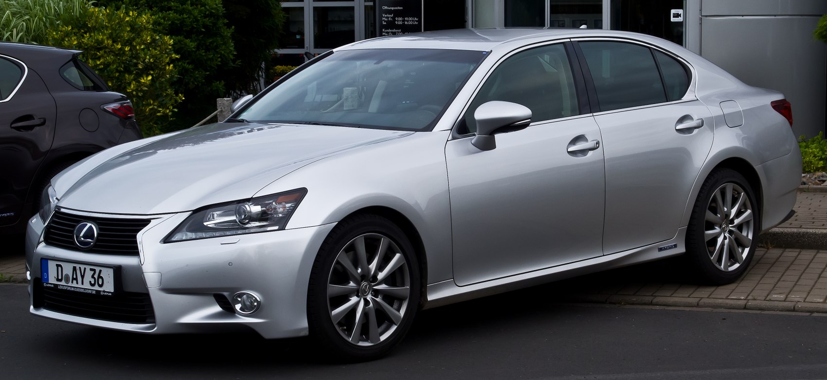 Silver sedan front side view with angular headlights and alloy wheels