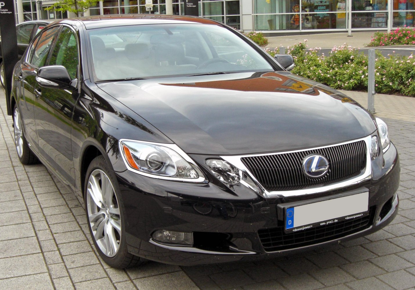 Front and side view of luxury sedan with updated grille and headlights