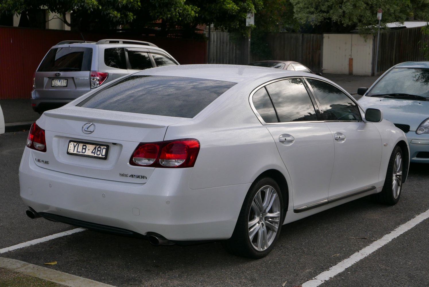 Rear left side view of white luxury sedan with distinctive taillights and alloy wheels