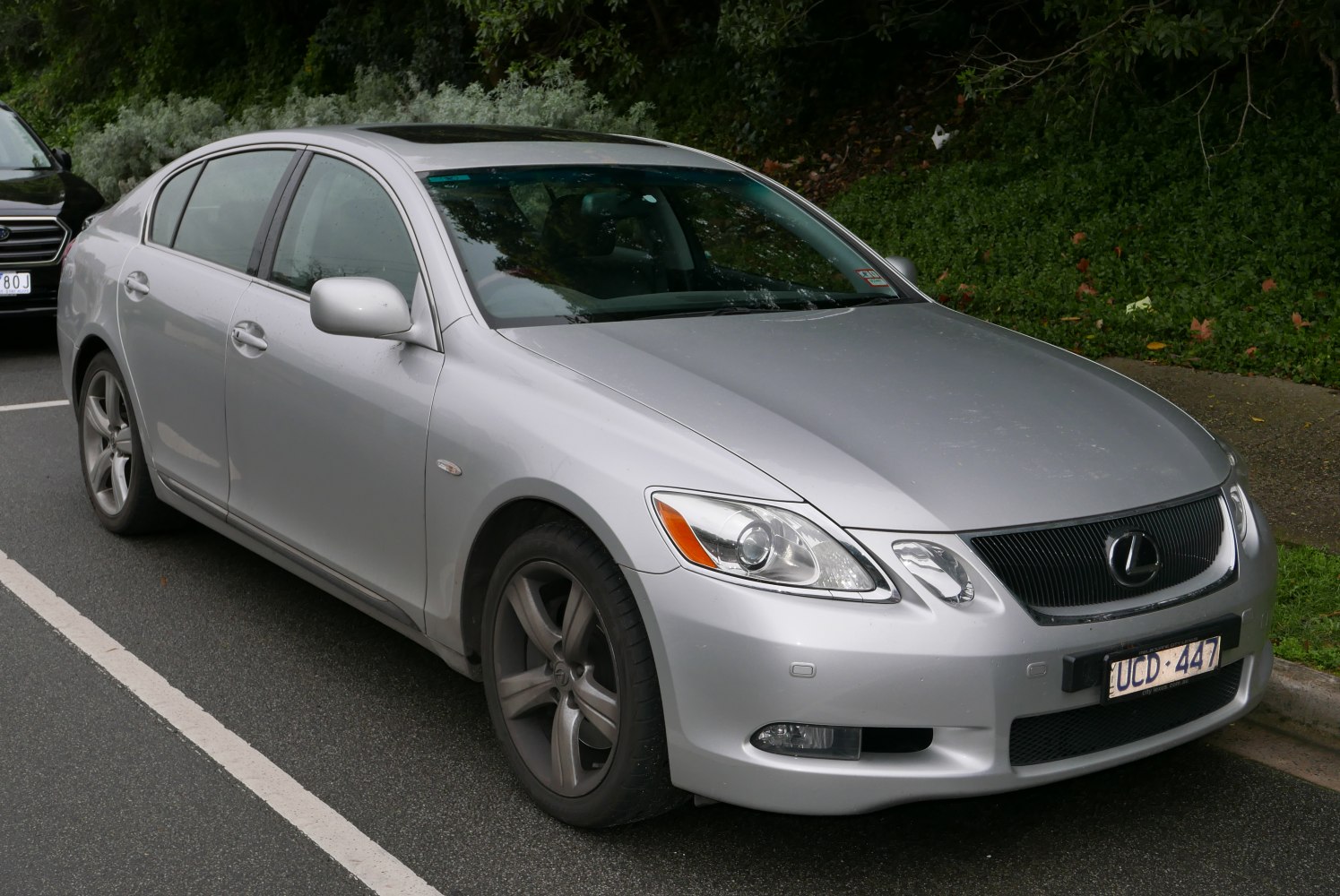 Silver sedan with sleek headlights and alloy wheels